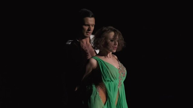 Partner turns girl to Rumba Shadow Position and rounding right arm touches her left shoulder. Dancer performs full right turn, bends back leaning on male arm, returns to position and resting in