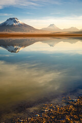 Salt lake Lejia reflection, idyllic volcanic landscape at Sunset, Atacama, Chile