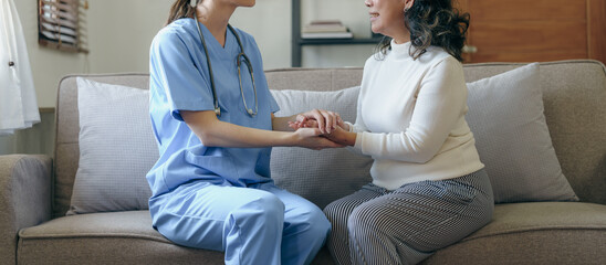 Portrait of attractive young caucasian female nurse elderly caregivers with senior patient home...