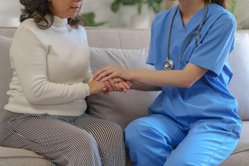 Fototapeta premium Female doctor taking a history of a patient and counseling on orthopedic diseases with female patients after measuring blood pressure and heart rate in a medical facility
