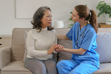 Female doctor taking a history of a patient and counseling on orthopedic diseases with female patients after measuring blood pressure and heart rate in a medical facility