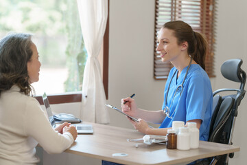 Fototapeta premium Female doctor taking a history of a patient and counseling on orthopedic diseases with female patients after measuring blood pressure and heart rate in a medical facility