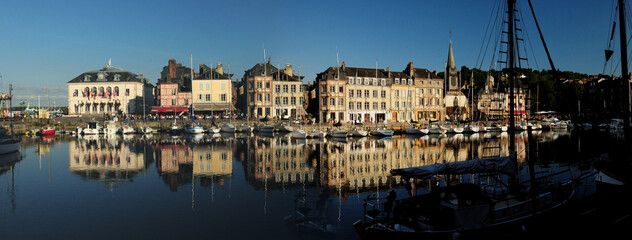 Historic Buildings Reflecting In The Water Of The Old Harbour In Honfleur Normandy France On A Beautiful Sunny Summer Day With A Clear Blue Sky - obrazy, fototapety, plakaty