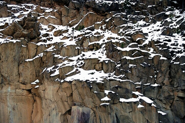 Rock face and snow in Yellowstone Park, US, fall.