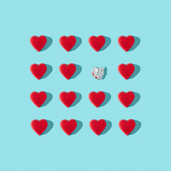 Trendy love composition made of Red heart chocolates on blue background. Minimal concept of Valentine's Day or love. Creative art, minimal aesthetics. Top view. Flat lay