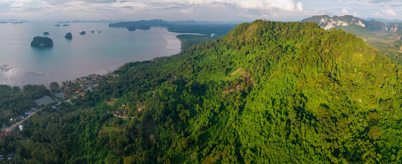 Fototapeta na wymiar Panoramic aerial view of Andaman Sea and cowered with jungle rocks in the area of Thalane beach at sunset. Krabi Province, Thailand.