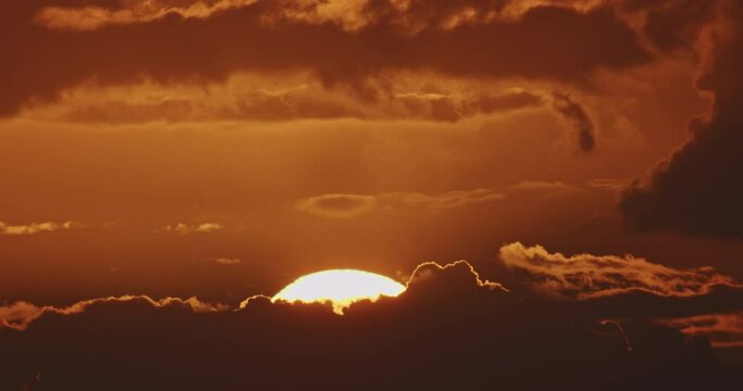 Sunrise timelapse, close up of big sun rising through clouds. Beautiful nature background time laps.