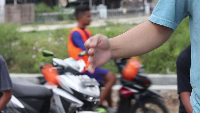 Teenagers playing Clacker Balls, also known as Latto-Latto in Indonesia. Lato lato