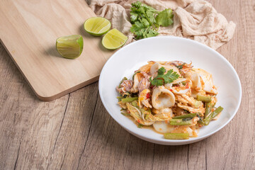 Sukiyaki dried squid Thai food in white bowl on wooden background