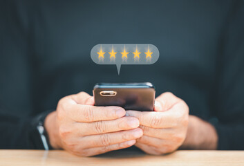 Businessman or Business people are touching a virtual screen on happy Smiley face icon symbol to give satisfaction in service. rating very impressed. Satisfaction survey and Customer service concept.