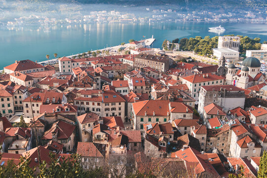 Kotor, Montenegro, beautiful top panoramic view of Kotor city old medieval town seen from San Giovanni St. John Fortress, with Adriatic sea, bay of Kotor and Dinaric Alps mountains in a sunny day