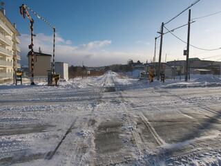 Hokkaido, Japan - January 25, 2023: Taisho rail crossing under strong wind in Nemuro, Hokkaido, Japan.

