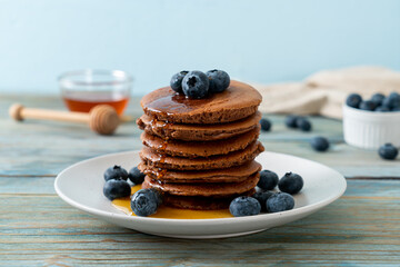 chocolate pancake stack with blueberry and honey