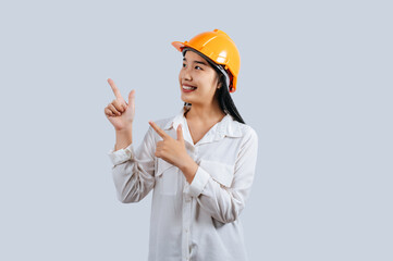 Young asian engineer female standing with point finger posture