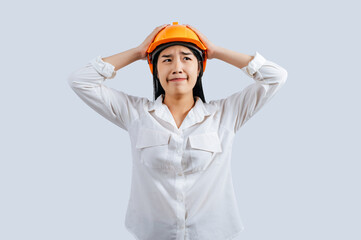 Young female engineer in helmet stand with thoughtful posture