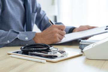 Fototapeta premium Male doctor write prescription 
