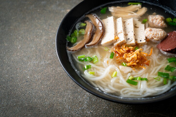 Vietnamese Rice Noodles Soup with Vietnamese Sausage served vegetables and crispy onion