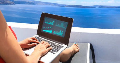 Nomad digital with laptop and running remotely with bright scenic view of the Mediterranean Sea and...