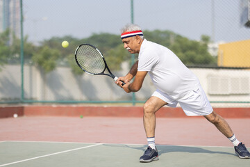 Senior man tennis player on tennis court.