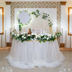 Table and wall decoration with fresh flowers for the bride and groom their wedding day.