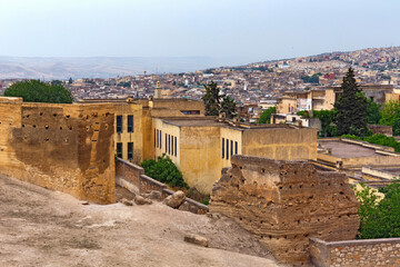 Fototapeta na wymiar View of the shabby poverty old buildings near the Fez el Bali medina. Is the oldest walled part of Fez, Morocco. Fes el Bali was founded as the capital of the Idrisid dynasty between 789 and 808 AD