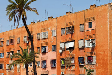 Naklejka premium View of the red walls shabby residential buildings in Marrakech on a sunny day. Morocco.