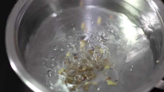 Adding lentil,bean in saucepan water for soup, stew, slow motion