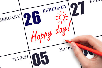 Hand writing the text HAPPY DAY and drawing the sun on the calendar date February 26