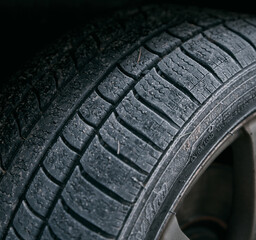 Close-up of car wheels rubber tires in winter snow. Concept of transportation and safety during the...