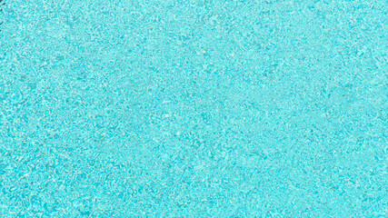Fototapeta na wymiar Background of swimming poll surface with ripple and sun reflections, top view water texture.