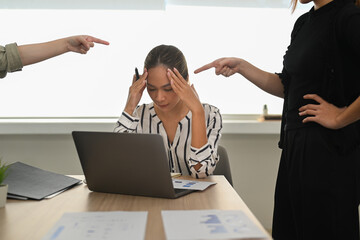 Frustrated young female employee receiving unfair reprimand rebuke, suffers from bad attitude at...