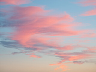 Beautiful sunset or sunrise sky background, blue sky with pink clouds.