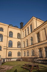 Old yellow 1850s houses at the block Kungliga Myntet, royal mint, facades, chimneys, and dorms a winter day in Stockholm