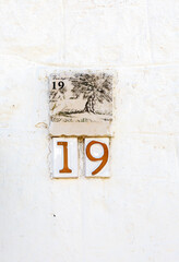 Ceramic street number on the wall