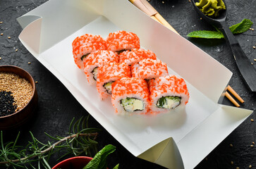 Japanese food. Sushi rolls with caviar. Food delivery. Free space for text.