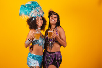 two Brazilian women friends, in carnival clothes. Drinking beer
