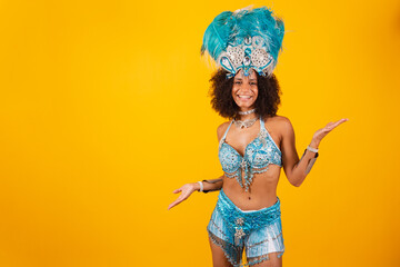 black woman queen of Brazilian samba school, with blue carnival clothes and crown of feathers. With...