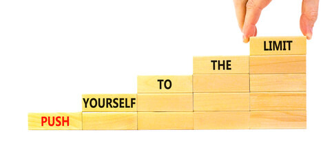 Push the limit symbol. Concept words Push yourself to the limit on wooden blocks. Beautiful white table white background. Businessman hand. Business push the limit concept. Copy space.