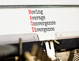 MACD symbol. Concept words MACD moving average convergence divergence typed on retro typewriter on beautiful white background. Business MACD moving average convergence divergence concept. Copy space.