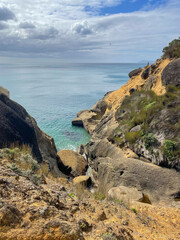 Coastline with turquoise sea and rocks, near Waihi beach, New Zealand.