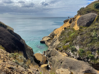 Fototapeta na wymiar Coastline with turquoise sea and rocks, near Waihi beach, New Zealand.