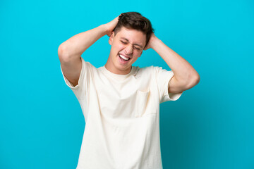 Young handsome Brazilian man isolated on blue background laughing