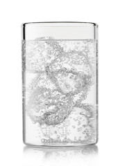 Mineral sparkling water lemonade with ice cubes in highball glass on white background.