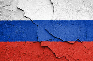 Flag of Russia painted on a craced wall. Embargo and sanctions for military aggression. 