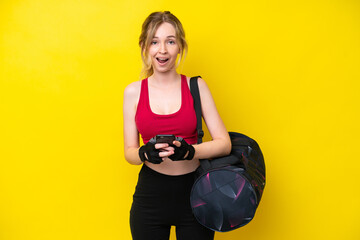 Young sport caucasian woman with sport bag isolated background surprised and sending a message