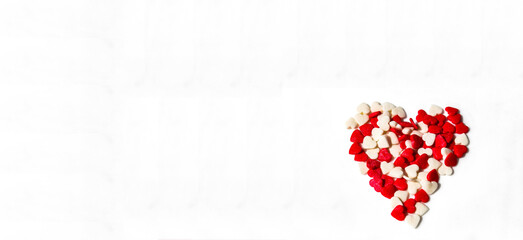 Banner of red and white hearts form a heart shape on a white background. Isolated heart shape. The concept of love and romance. Romantic background composition. Valentine's Day