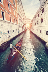 Gondola on canal with the Bridge of Sighs in Venice, Italy