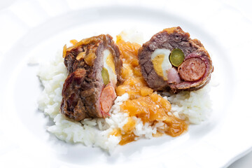 beef roulade filled with egg, sausage, bacon and prickle served with rice