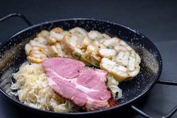 smoked meat served with sauerkraut and dumplings