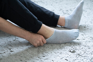 person holding a sock and put it on in the morning